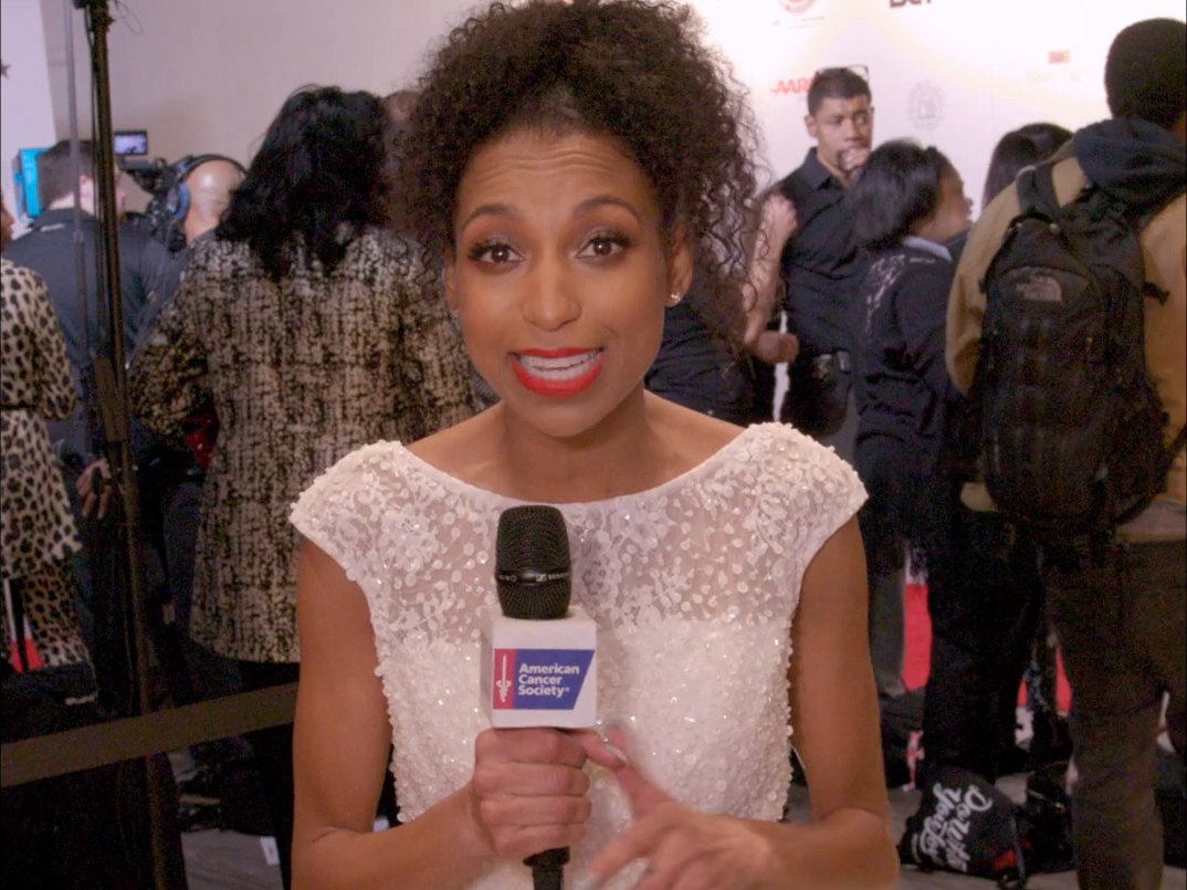 Chelsea reporting with an American Cancer Society mic on the Super Bowl Gospel Celebration red carpet