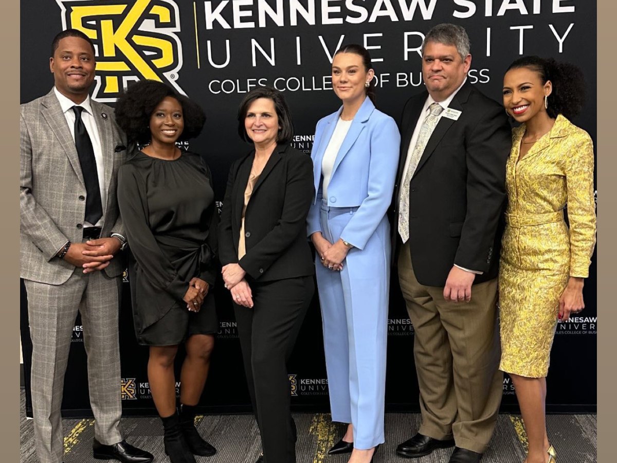 Chelsea with honorees and Coles College of Business leaders in front of the Kennesaw State University backdrop